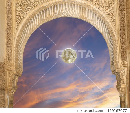 Arches in Islamic (Moorish) style (against the sunset with the super moon) in Alhambra, Granada, Spain  139167077