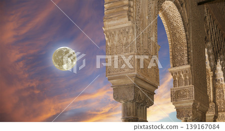 Arches in Islamic (Moorish) style (against the sunset with the super moon) in Alhambra, Granada, Spain Arches in Islamic (Moorish) style (against the sunset with the super moon) in Alhambra, Granada, Spain 139167084