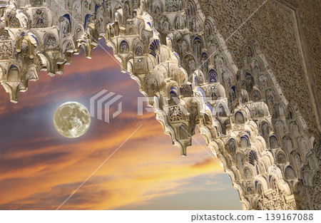 Arches in Islamic (Moorish) style (against the sunset with the super moon) in Alhambra, Granada, Spain Arches in Islamic (Moorish) style (against the sunset with the super moon) in Alhambra, Granada, Spain 139167088
