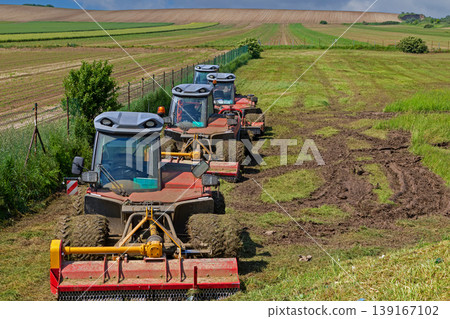 Lawn mover cabins on a foeld Lawn mover cabins on a foeld 139167102