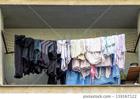 Wet laundry drying on balcony Wet laundry drying on balcony 139167122