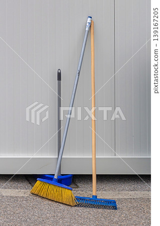 Brooms cleaning equipment outside on street Brooms cleaning equipment outside on street 139167205