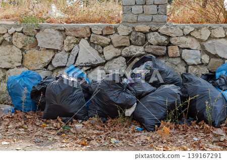 Pile of plastic garbage bags left outside 139167291