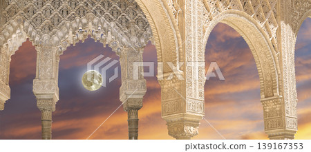 Arches in Islamic (Moorish) style (against the sunset with the super moon) in Alhambra, Granada, Spain  139167353