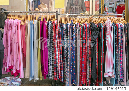 Colorful clothes hanging on racks 139167615
