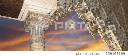 Arches in Islamic (Moorish) style (against the sunset with the super moon) in Alhambra, Granada, Spain        139167669