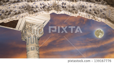 Arches in Islamic (Moorish) style (against the sunset with the super moon) in Alhambra, Granada, Spain        139167776