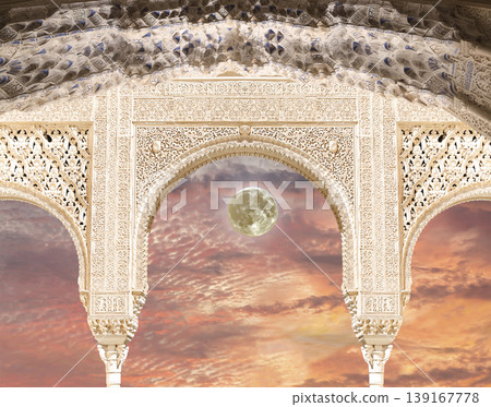 Arches in Islamic (Moorish) style (against the sunset with the super moon) in Alhambra, Granada, Spain        139167778