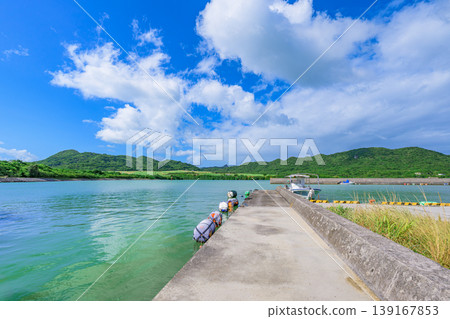 Ishigaki Island: The quay of Funakoshi Fishing Port, overlooking the emerald sea. Ishigaki Island: The quay of Funakoshi Fishing Port, overlooking the emerald sea. 139167853