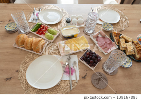 Close view of breakfast table with various foods. Nutrition and lifestyle. Food selection on table. Healthy eating Close view of breakfast table with various foods. Nutrition and lifestyle. Food selection on table. Healthy eating 139167883