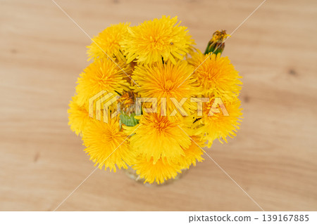 op view of bright dandelion bouquet. Floral texture and spring concept. Yellow flowers arranged in minimal composition. Nature and seasonal theme. op view of bright dandelion bouquet. Floral texture and spring concept. Yellow flowers arranged in minimal composition. Nature and seasonal theme. 139167885