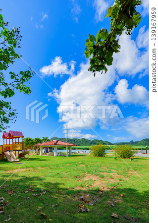 Ishigaki Island: A relaxing plaza at Funakoshi Fishing Port, where shade from trees and grass make for a pleasant atmosphere. Ishigaki Island: A relaxing plaza at Funakoshi Fishing Port, where shade from trees and grass make for a pleasant atmosphere. 139167959