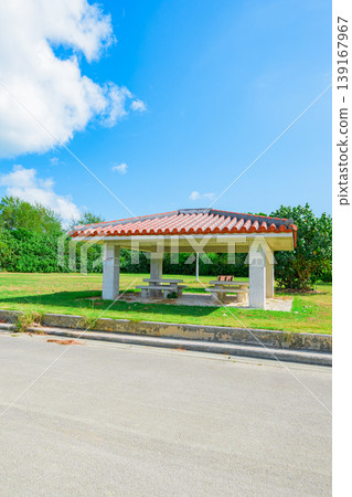 Ishigaki Island: The grassy area of Funakoshi Fishing Port, where a red-tiled gazebo stands out. Ishigaki Island: The grassy area of Funakoshi Fishing Port, where a red-tiled gazebo stands out. 139167967