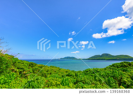 The breathtaking scenery of Ishigaki Island, with its blue sea and lush green island silhouettes. The breathtaking scenery of Ishigaki Island, with its blue sea and lush green island silhouettes. 139168368