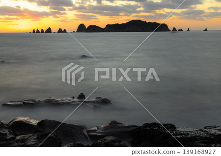 A sunrise over Nanatsu-iwa in the Hyuga Sea off Nichinan City, Miyazaki Prefecture, and the sea surface resembling a sea of clouds, captured with a slow shutter speed. A sunrise over Nanatsu-iwa in the Hyuga Sea off Nichinan City, Miyazaki Prefecture, and the sea surface resembling a sea of clouds, captured with a slow shutter speed. 139168927