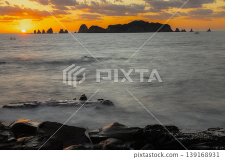 A sunrise over Nanatsu-iwa in the Hyuga Sea off Nichinan City, Miyazaki Prefecture, and the sea surface resembling a sea of clouds, captured with a slow shutter speed. A sunrise over Nanatsu-iwa in the Hyuga Sea off Nichinan City, Miyazaki Prefecture, and the sea surface resembling a sea of clouds, captured with a slow shutter speed. 139168931