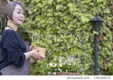 Senior women enjoying gardening in their yards 139169678