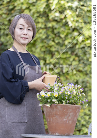 Senior women enjoying gardening in their yards Senior women enjoying gardening in their yards 139169691