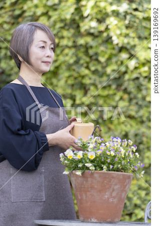 Senior women enjoying gardening in their yards Senior women enjoying gardening in their yards 139169692