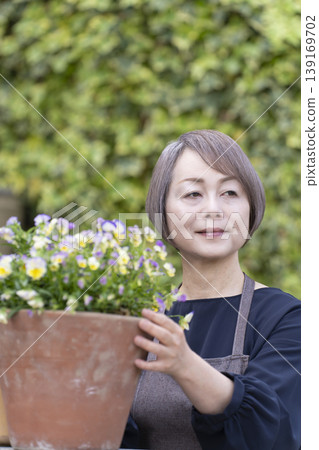 老年婦女們在自家院子裡享受園藝的樂趣 老年婦女們在自家院子裡享受園藝的樂趣 139169702