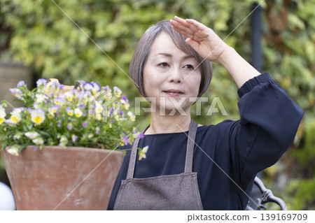 Senior women enjoying gardening in their yards 139169709