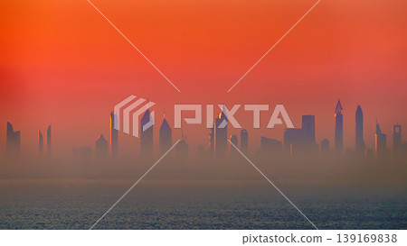 Dubai, United Arab Emirates - Jan 12 2024, Panoramic view of downtown Dubai skyscrapers, with Burj Khalifa in the middle, at dawn in a haze, a view from the sea, Dubai, United Arab Emirates Dubai, United Arab Emirates - Jan 12 2024, Panoramic view of downtown Dubai skyscrapers, with Burj Khalifa in the middle, at dawn in a haze, a view from the sea, Dubai, United Arab Emirates 139169838