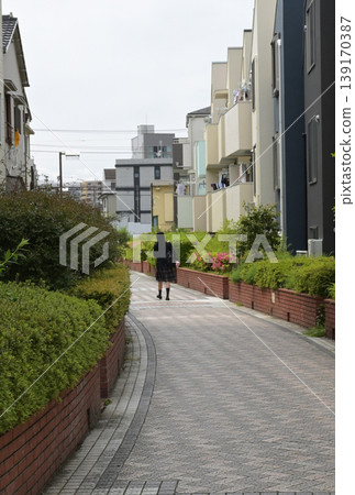 A figure walking along the promenade A figure walking along the promenade 139170387