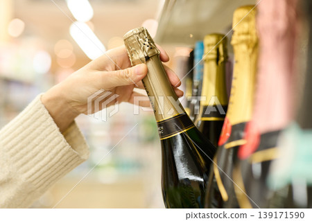 Pick up a bottle of wine 139171590