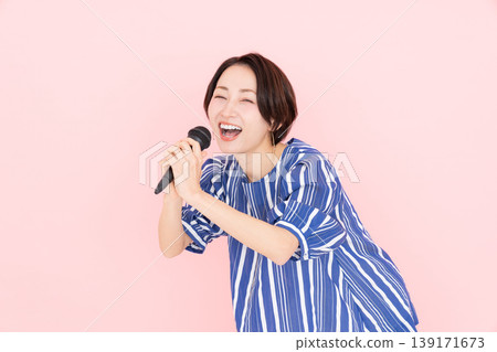 Middle-aged woman singing karaoke 139171673
