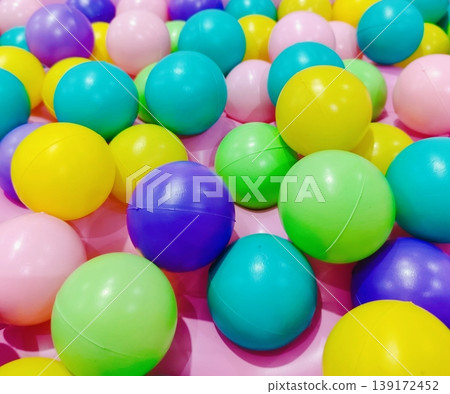 A variety of small, colorful plastic balls that create a fun and lively atmosphere. A variety of small, colorful plastic balls that create a fun and lively atmosphere. 139172452