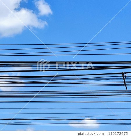photo of electrical cable installation hanging above with blue sky background photo of electrical cable installation hanging above with blue sky background 139172475