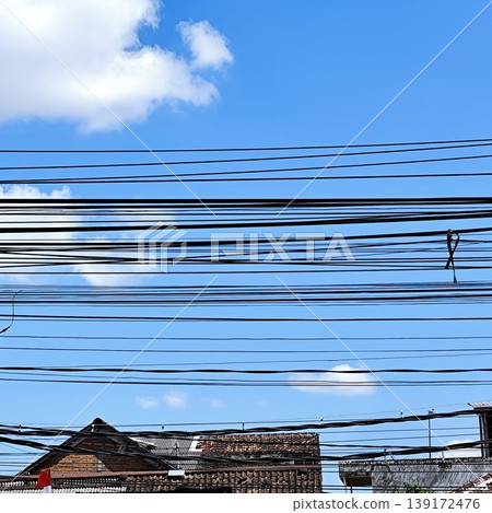 photo of electrical cable installation hanging above with blue sky background photo of electrical cable installation hanging above with blue sky background 139172476