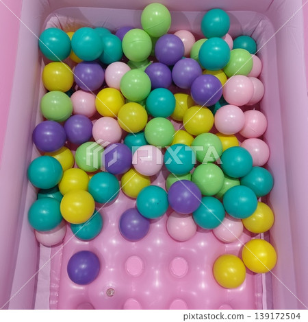 A variety of small, colorful plastic balls that create a fun and lively atmosphere. 139172504