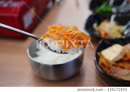 A Spoonful of Steamed White Rice Topped with Sizzling Korean Kimchi Stew A Spoonful of Steamed White Rice Topped with Sizzling Korean Kimchi Stew 139172959