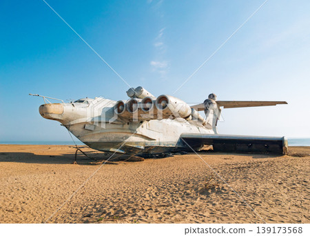Abandoned Lun-class ekranoplan on a deserted beach near the Caspian Sea under a clear blue sky Abandoned Lun-class ekranoplan on a deserted beach near the Caspian Sea under a clear blue sky 139173568
