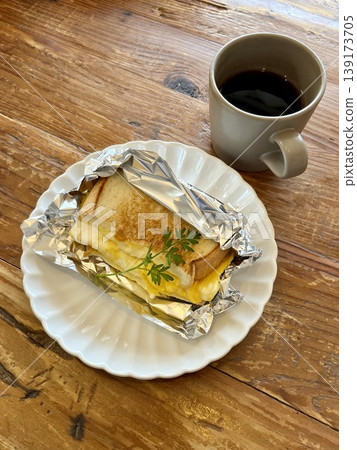Hot sandwich and coffee breakfast set, with a wooden table image. Hot sandwich and coffee breakfast set, with a wooden table image. 139173705