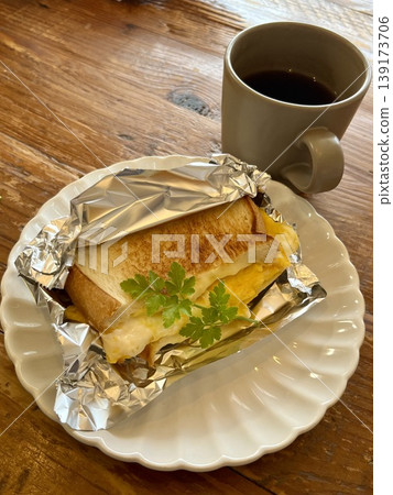 Hot sandwich and coffee breakfast set, with a wooden table image. Hot sandwich and coffee breakfast set, with a wooden table image. 139173706