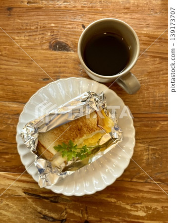 Hot sandwich and coffee breakfast set, with a wooden table image. Hot sandwich and coffee breakfast set, with a wooden table image. 139173707