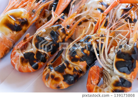 Close up grilled river prawns with charred shells on white plate juicy seafood texture rich flavor Asian cuisine appetizing dish fresh cooked and ready to serve Close up grilled river prawns with charred shells on white plate juicy seafood texture rich flavor Asian cuisine appetizing dish fresh cooked and ready to serve 139173808