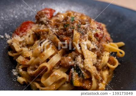 Fettuccine with Bolognese sauce served in a black bowl Fettuccine with Bolognese sauce served in a black bowl 139173849