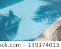 Tropical travel vacation wallpaper design amazing summer abstract background palm leaf shadows on calm swimming pool water sunshine aesthetic ripple texture sunlight serene leisure scene 139174013