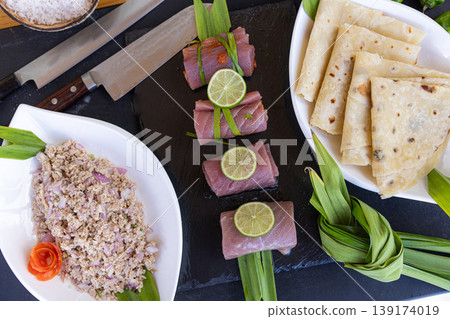 Professional gourmet kitchen cutting board raw fish prepared fillet ingredients knife spices lemon herbs healthy seafood cooking background culinary preparation aromatic food composition Professional gourmet kitchen cutting board raw fish prepared fillet ingredients knife spices lemon herbs healthy seafood cooking background culinary preparation aromatic food composition 139174019