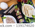 Fresh raw prepared fish on gourmet kitchen cutting board with ingredients knife spices lemon herbs culinary background healthy seafood cooking preparation aromatic food concept flat lay 139174020