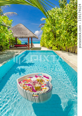 Summer travel couple honeymoon private pool floating breakfast tropical beach resort palm trees ocean view radiant relaxing luxury tourism background romantic honeymooners paradise leisure 139174024