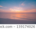 Sunset beach calm waves relaxation ocean sand sky summer nature shore background travel tropical idyllic water horizon golden hour coastal paradise peaceful seaside vista majestic landscape 139174026