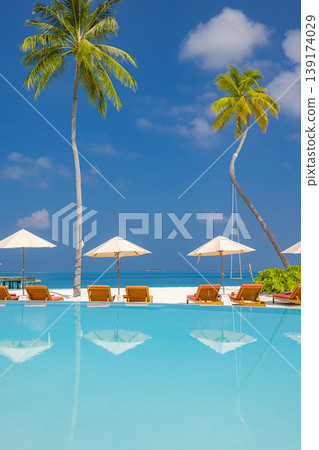 Tranquil reflection of luxury resort pool sunbeds umbrellas and palm trees summer travel background perfect tropical tourism scenery elegant poolside lounge area premium vacation atmosphere Tranquil reflection of luxury resort pool sunbeds umbrellas and palm trees summer travel background perfect tropical tourism scenery elegant poolside lounge area premium vacation atmosphere 139174029