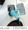 Charging scene at an electric vehicle charging station. 139174051