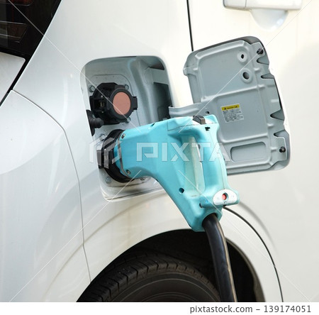 Charging scene at an electric vehicle charging station. Charging scene at an electric vehicle charging station. 139174051