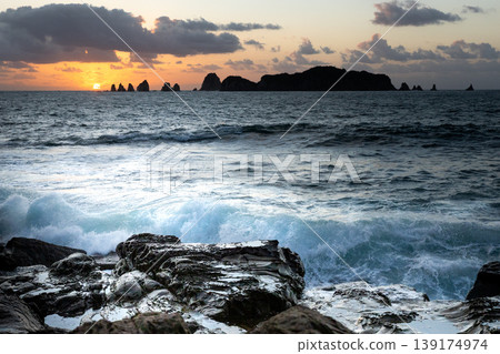 Sunrise and crashing waves off the coast of Nanatsu-iwa in the Hyuga Sea, Nichinan City, Miyazaki Prefecture. Sunrise and crashing waves off the coast of Nanatsu-iwa in the Hyuga Sea, Nichinan City, Miyazaki Prefecture. 139174974