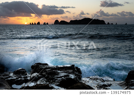 Sunrise and crashing waves off the coast of Nanatsu-iwa in the Hyuga Sea, Nichinan City, Miyazaki Prefecture. Sunrise and crashing waves off the coast of Nanatsu-iwa in the Hyuga Sea, Nichinan City, Miyazaki Prefecture. 139174975